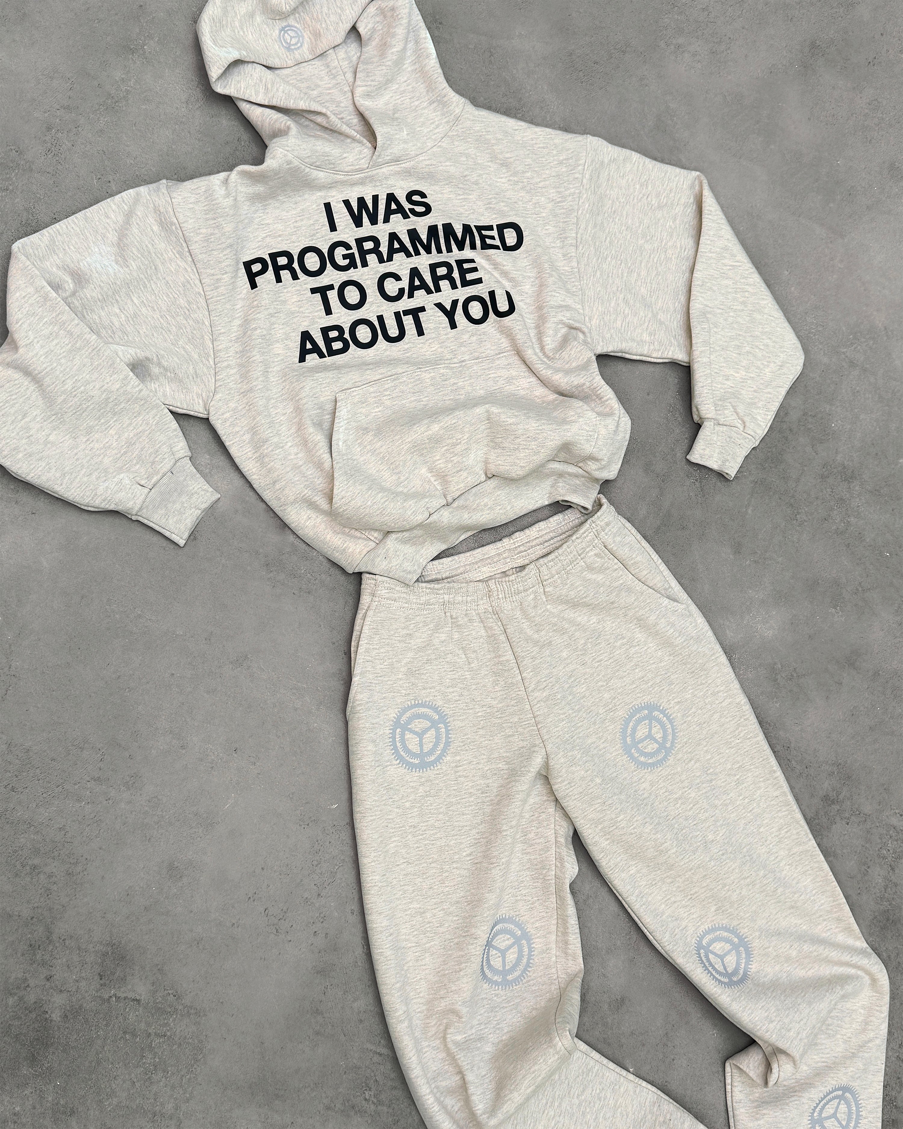 "PROGRAMMED TO CARE" HOODIE